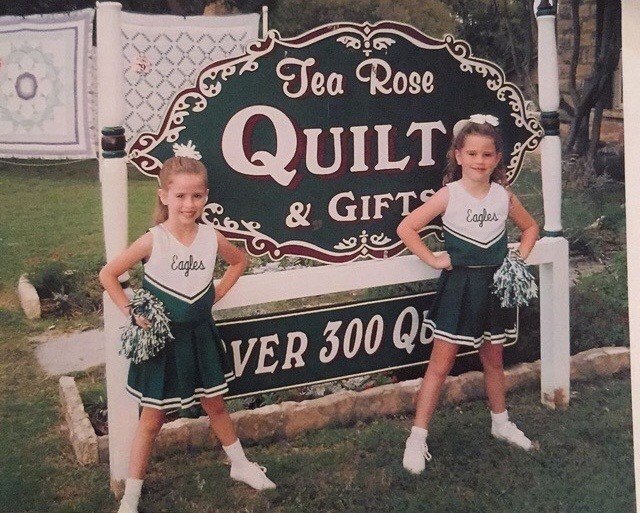 Savannah Sikes as a young girl in front of her family’s Tea Rose Quilts store on Main Street in Fredericksburg
