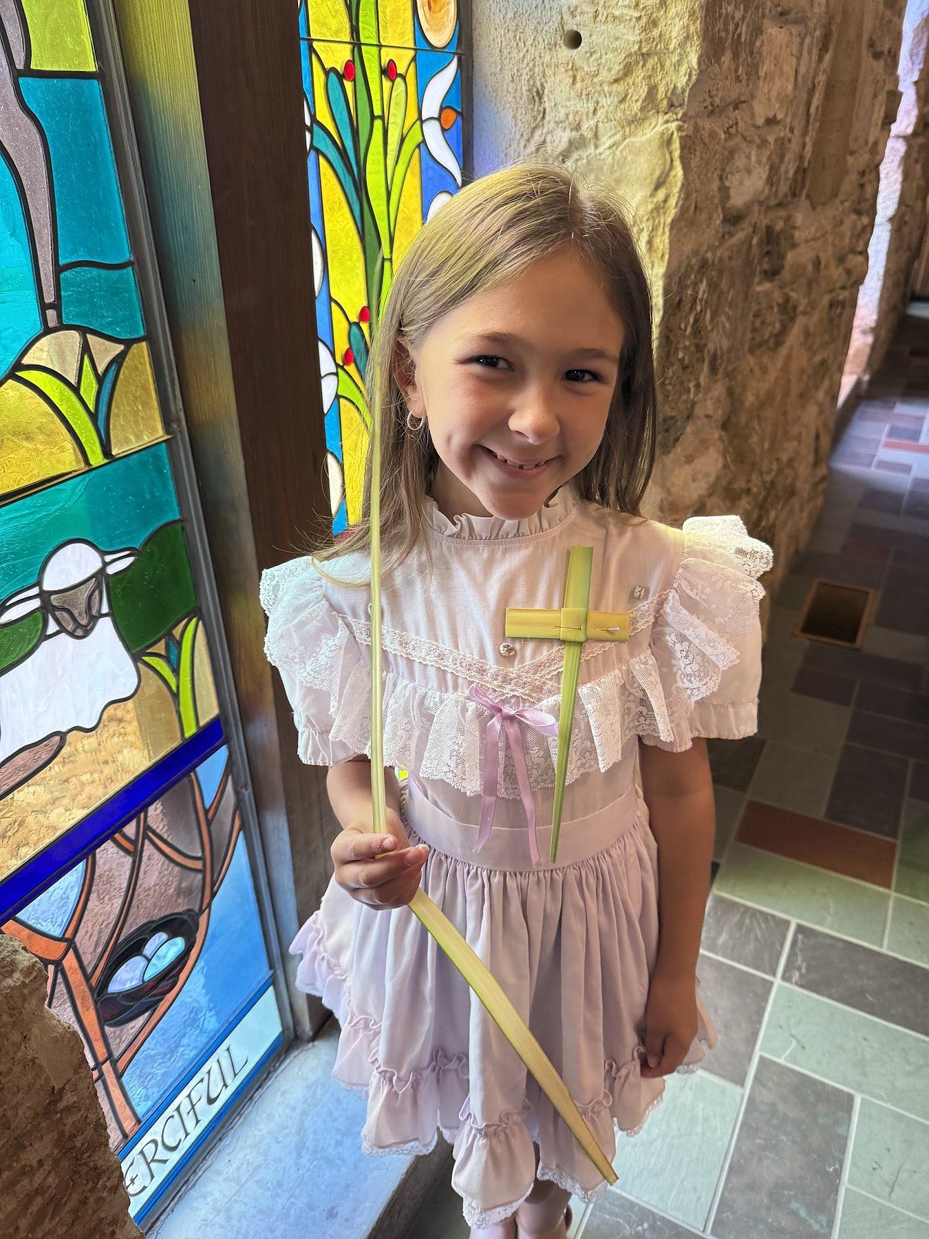 A child with a palm on Palm Sunday at St. Barnabas