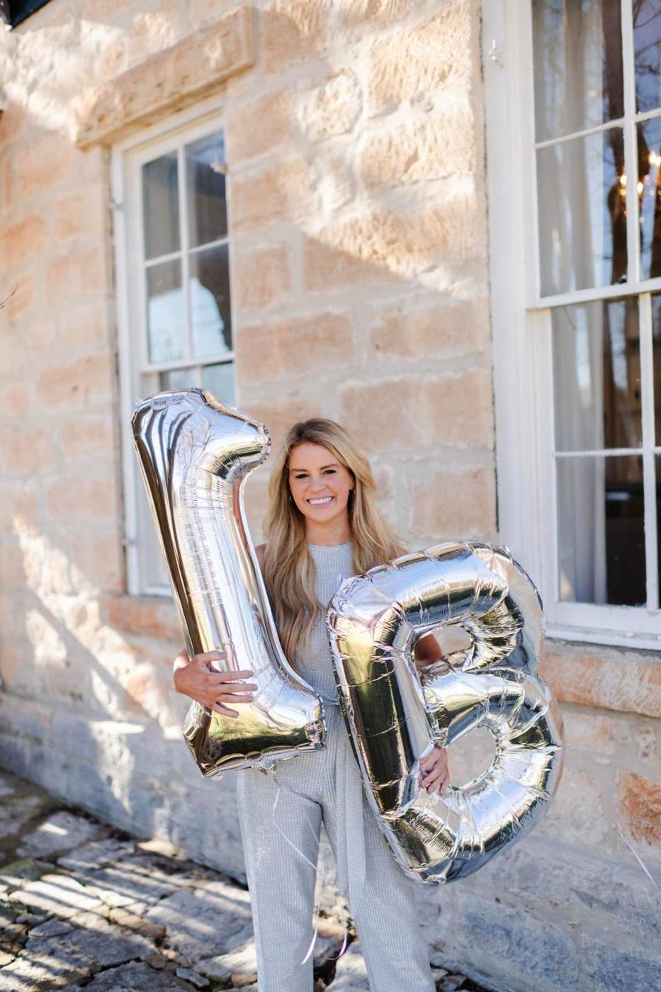 Savannah Sikes with 1B balloons at the Absolute Charm office