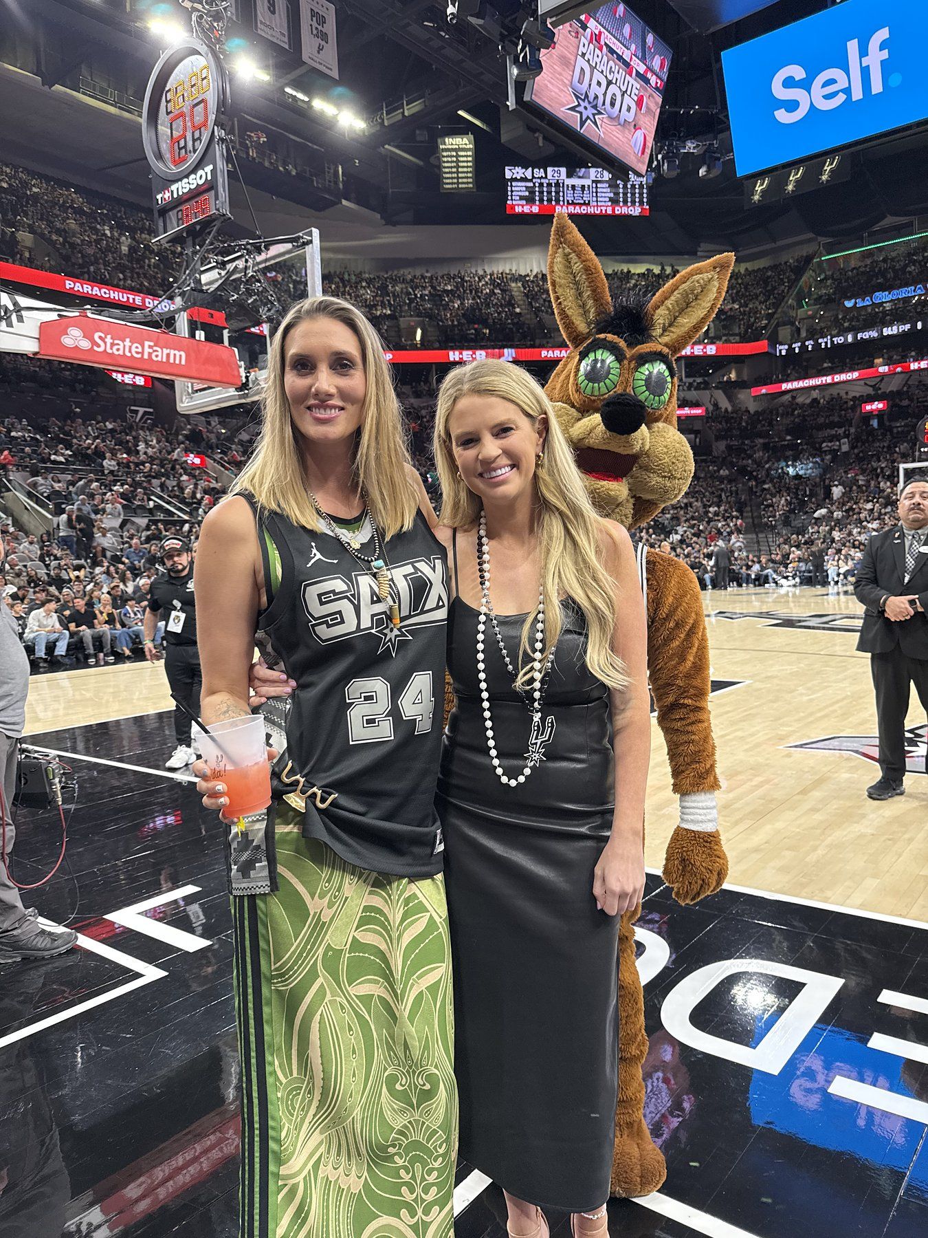 Savannah Sikes and a friend courtside with the Spurs Coyote